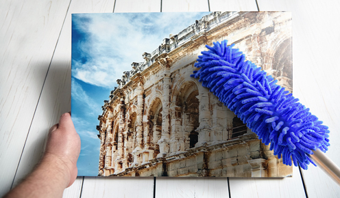 Cleaning canvas with a feather duster