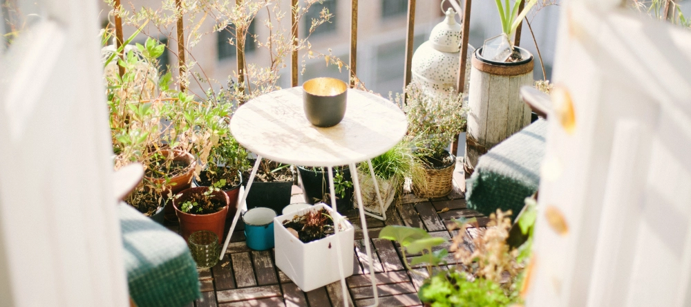 Decorating ideas for balcony. Beautiful balcony with plants and coffee table.