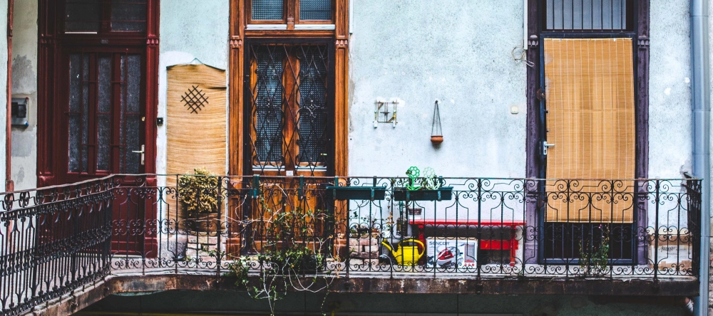 Decorating ideas for balcony. Big spacious balcony with plants and iron railing.