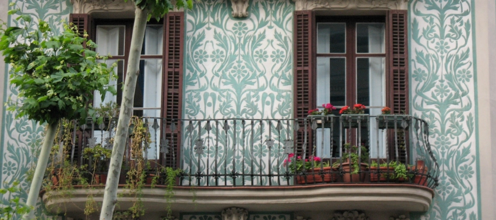 Decorating ideas for balcony. Balcony with iron railing, plants and decorative patterns.